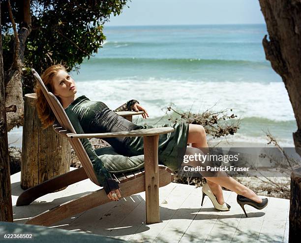 Hair by Mark Townsend and makeup by Molly Stern. Devoré dress by Proenza Schouler with leather and lizard skin shoes by Alexander McQueen; gold and...