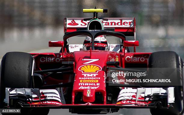 Scuderia Ferrari's driver Kimi Raikkonen tests the so-called halo cockpit protection device during first practice session of the Formula One...