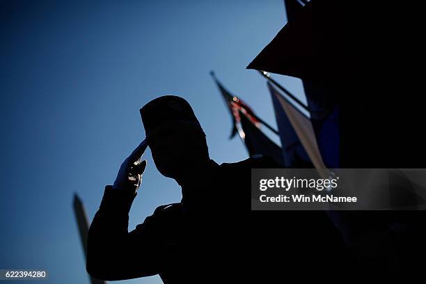 Veterans salute during the playing of the national anthem during a Veterans Day ceremony at the World War Two Memorial November 11, 2016 in...