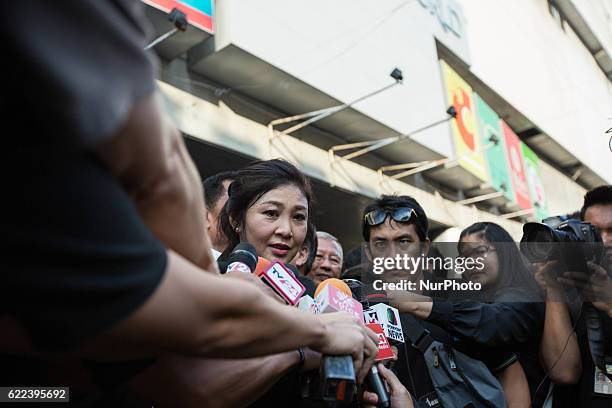 Thailand's Former Prime Minister Yingluck Shinawatra speaks to media after sold rice directly from the farmers outside Emperial Samrong Shopping Mall...