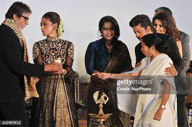 Indian Star Actor Amitabh Bachchan lighting a lamp along West Bengal Chief Minister Mamata Banerjee, Actor Shah Rukh Khan , Actor Sanjoy Dutta,...