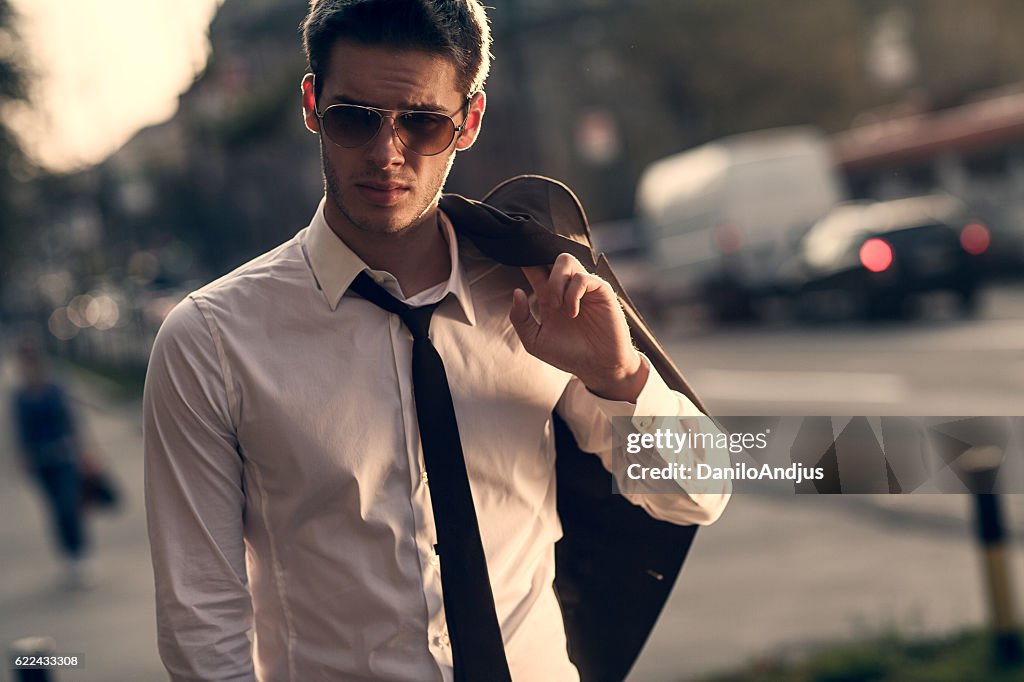 Young businessman walking home after work