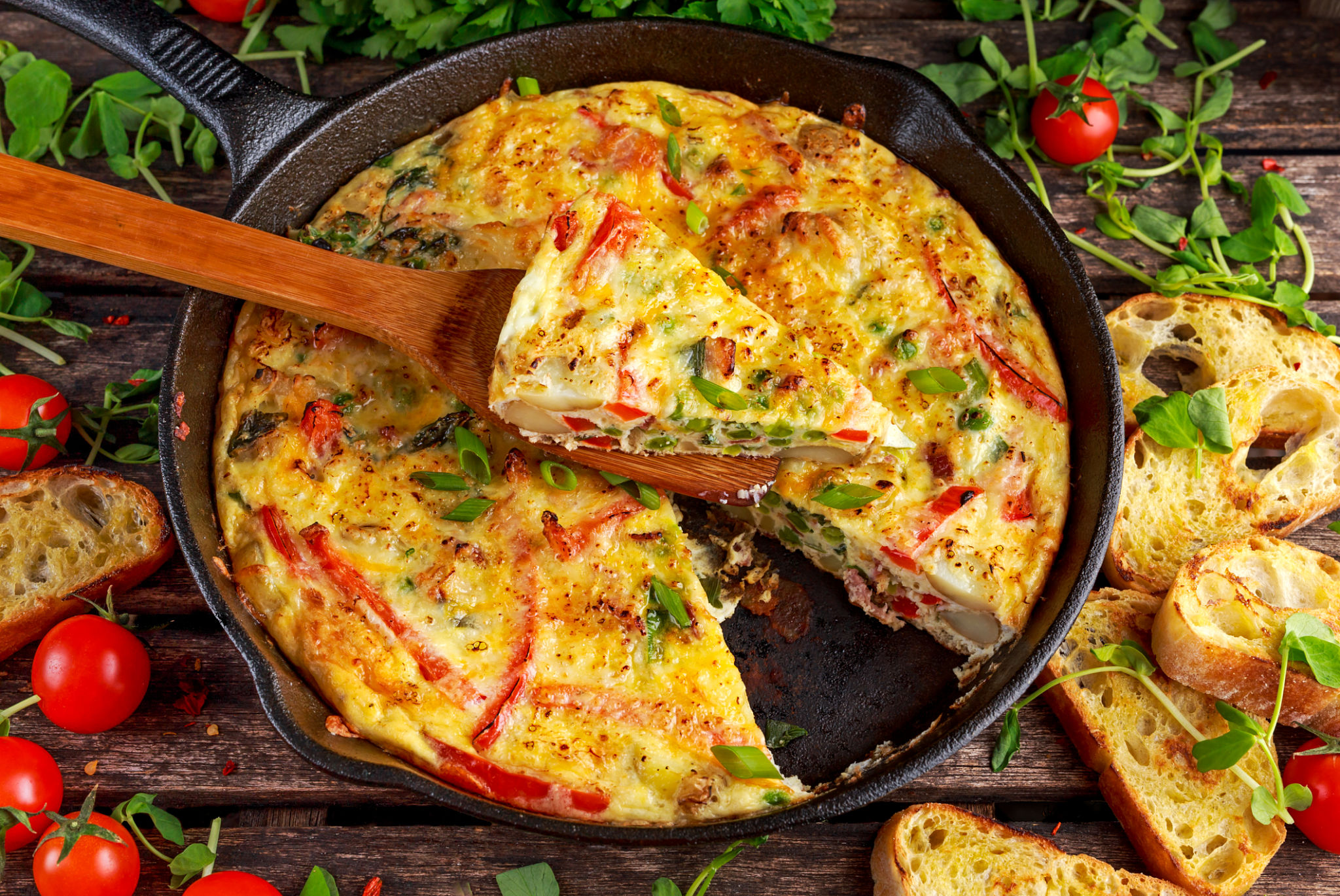 Frittata made of eggs, potato, bacon, paprika, parsley, green peas Frittata made of eggs, potato, bacon, paprika, parsley, green peas