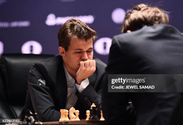 Chess grandmaster and current world chess champion Magnus Carlsen of Norway and challenger Sergey Karjakin of Russia concentrate during their World...