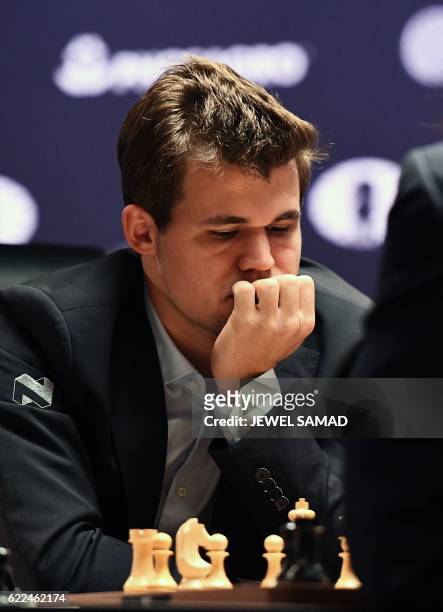 Chess grandmaster Magnus Carlsen of Norway concentrates during his World Chess Championship 2016 round 1 match against challenger Sergey Karjakin of...