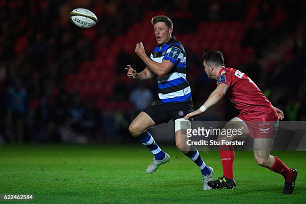 Bath fly half Rhys Priestland sets up the third Bath try with a pass during the Anglo-Welsh Cup match between Scarlets and Bath at Parc y Scarlets on...