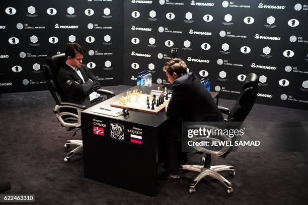 Chess grandmaster and current world chess champion Magnus Carlsen of Norway and challenger Sergey Karjakin of Russia concentrate during their World...