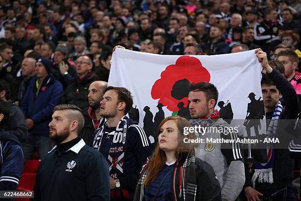 Scotland fans hold up a poppy flag during the minutes silence during the FIFA 2018 World Cup Qualifier between England and Scotland at Wembley...