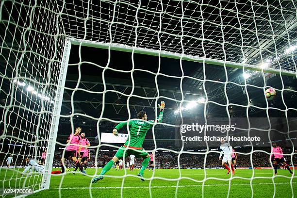 Daniel Sturridge of England beats goalkeeper Craig Gordon of Scotland to score their first goal during the FIFA 2018 World Cup qualifying match...