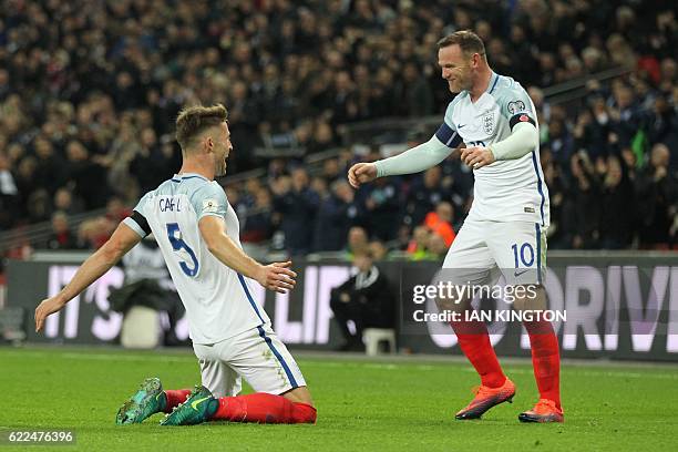 England's defender Gary Cahill celebrates with England's striker Wayne Rooney after scoring their third goal during a World Cup 2018 qualification...