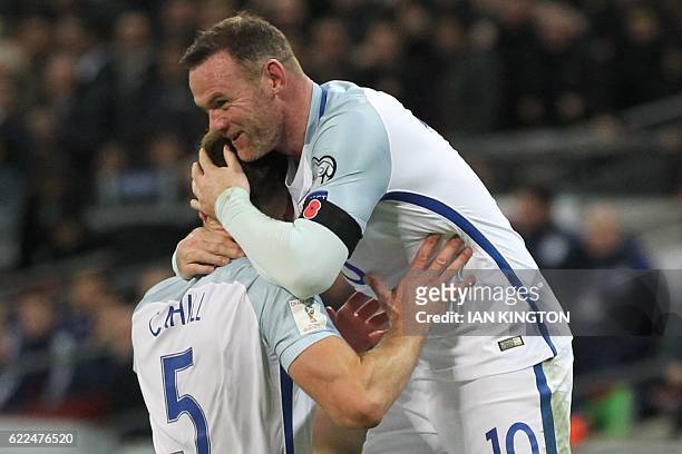 England's defender Gary Cahill celebrates with England's striker Wayne Rooney after scoring their third goal during a World Cup 2018 qualification...
