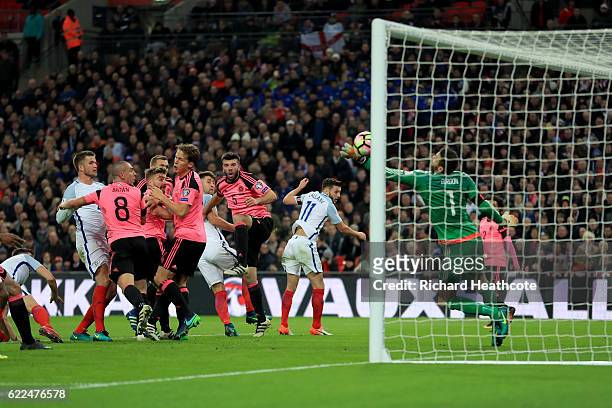 Gary Cahill of England scores their third goal past goalkeeper Craig Gordon of Scotland during the FIFA 2018 World Cup qualifying match between...