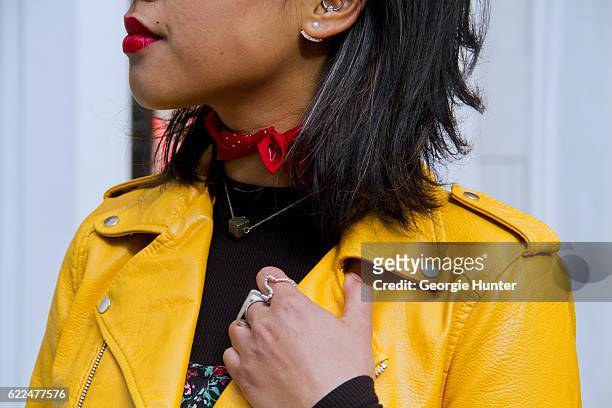 Tina Maria Tran with Urban Decay red lipstick wearing yellow pleather leather biker jacket with zips from Zara, black ribbed high neck top, red and...