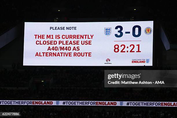 The stadium scoreboard shows a message informing fans that the M1 Motorway is closed during the FIFA 2018 World Cup Qualifier between England and...