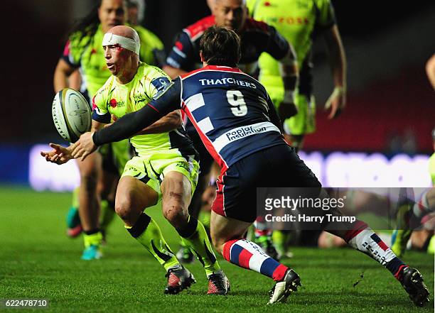Peter Stringer of Sale Sharks looks to break past Rhodri Williams of Bristol Rugby during the Anglo-Welsh Cup match between Bristol Rugby and Sale...