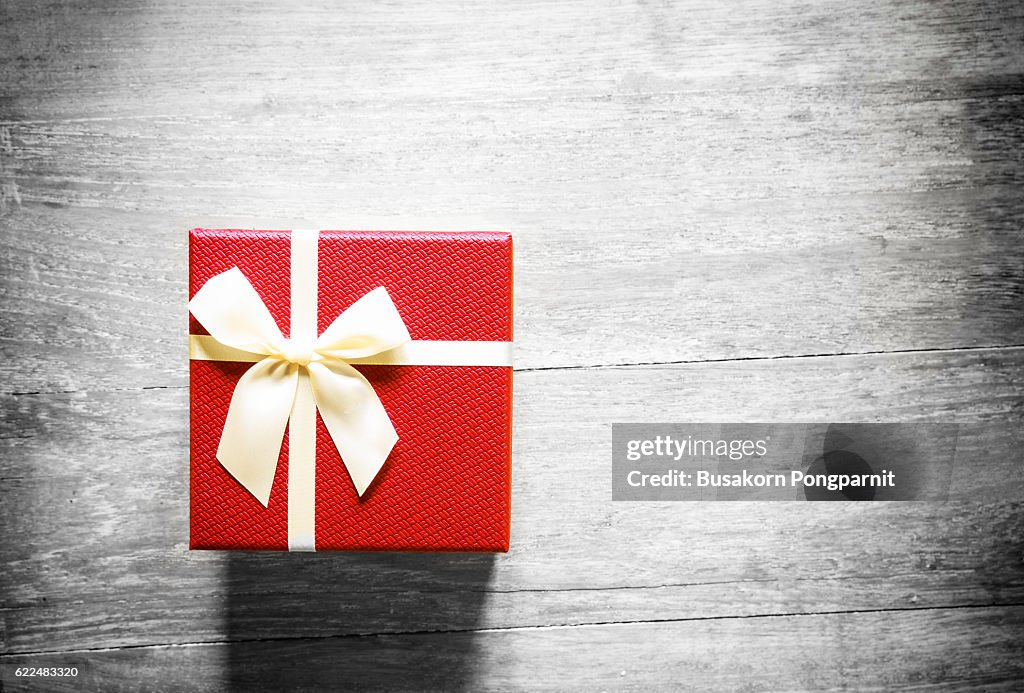 Red christmas gift box on wooden table