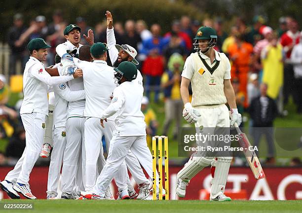 Vernon Philander of South Africa celebrates with team mates after taking the wicket of Adam Voges of Australia during day one of the Second Test...