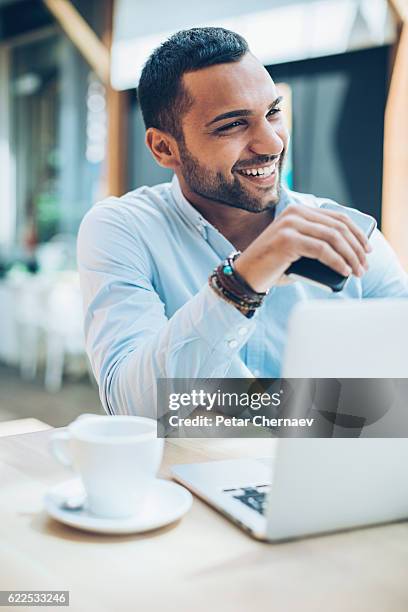 smiling middle eastern ethnicity businessman - digital fulfillment stock pictures, royalty-free photos & images