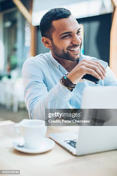 smiling middle eastern ethnicity businessman - arab on computer imagens e fotografias de stock