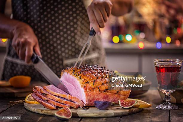 carving glazed holiday ham with cloves - pork cuts stock pictures, royalty-free photos & images