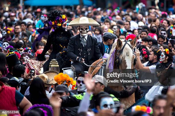 Participants who wear colorful costumes parade through the streets during the 'Catrinas Parade', a joyful annual event celebrated at the Day of the...