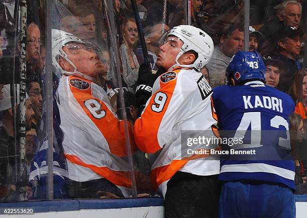 Nazem Kadri of the Toronto Maple Leafs hits Ivan Provorov of the Philadelphia Flyers into the glass during the second period at the Air Canada Centre...