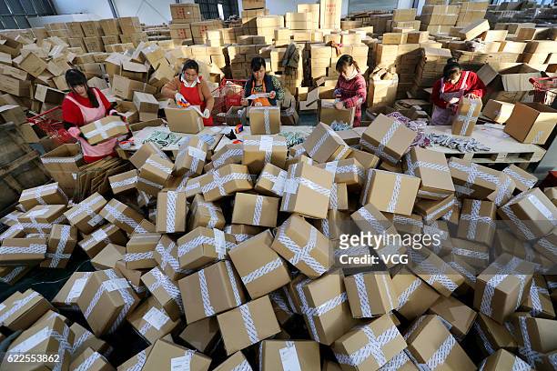 Workers distribute express parcels at a logistics centre of China Post during Alibaba Group's Singles' Day global shopping festival on November 11,...