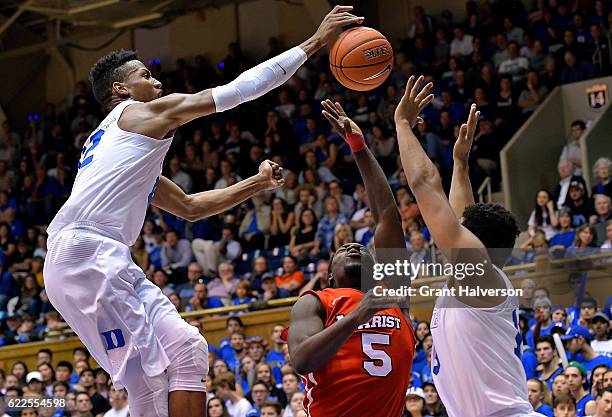 Javin DeLaurier of the Duke Blue Devils blocks a shot by Khallid Hart of the Marist Red Foxes during the game at Cameron Indoor Stadium on November...