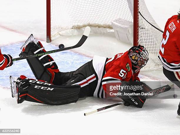 The pucks slips past Corey Crawford of the Chicago Blackhawks on a goal by Jay Beagle the Washington Capitals at the United Center on November 11,...