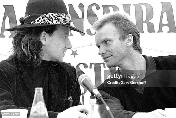 Rock musicians Bono , of the group U2, and Sting talk together during a press conference for Amnesty International's 'A Conspiracy of Hope' concert,...