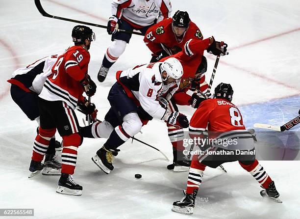 Alex Ovechkin of the Washington Capitals tries to control the puck surronded by Jonathan Toews, Brian Campbell, Duncan Keith and Nick Schmaltz of the...