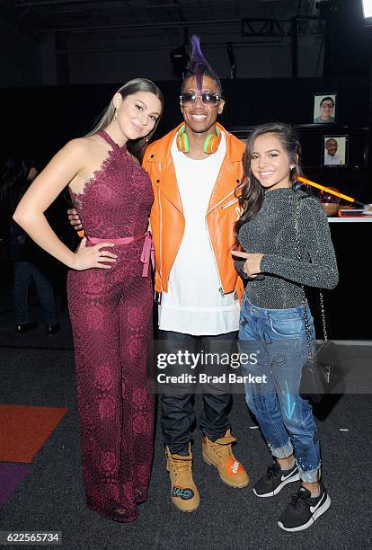 Kira Kosarin, Nick Cannon, and Isabela Moner pose backstage during the 2016 Nickelodeon HALO awards at Basketball City - Pier 36 - South Street on...