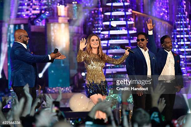 In this handout photo provided by Disney Parks, R&B group Boyz II Men Wanya Morris, Nathan Morris and Shawn Stockman perform with singer JoJo during...