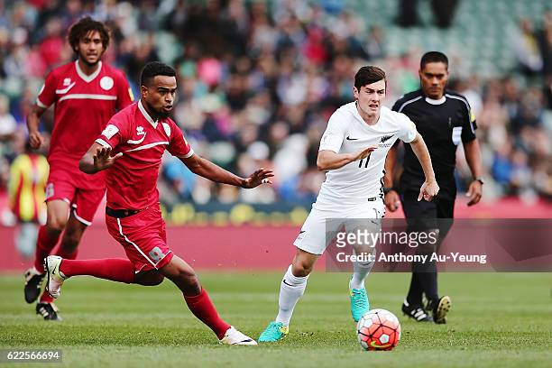 Marco Rojas of New Zealand competes against Emile Bearune of New Caledonia during the 2018 FIFA World Cup Qualifier match between the New Zealand All...