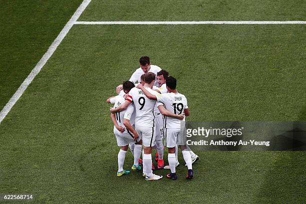 Marco Rojas of New Zealand is mobbed by teammates after scoring the second goal during the 2018 FIFA World Cup Qualifier match between the New...