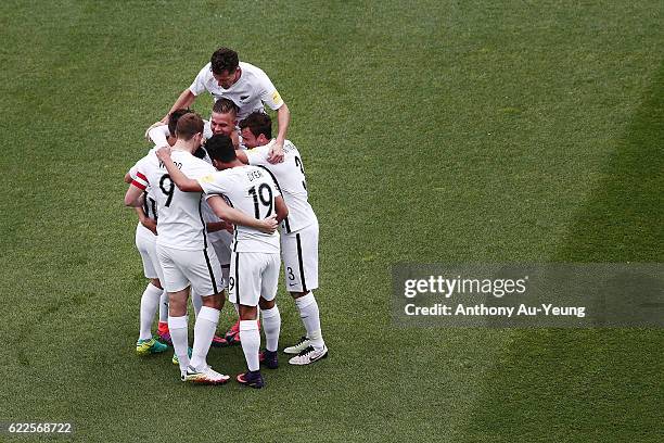 Marco Rojas of New Zealand is mobbed by teammates after scoring the second goal during the 2018 FIFA World Cup Qualifier match between the New...