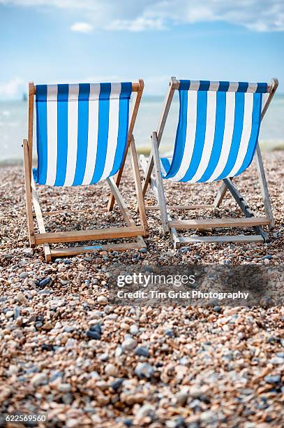 empty blue and white striped deck chairs - mawgan porth stock pictures, royalty-free photos & images
