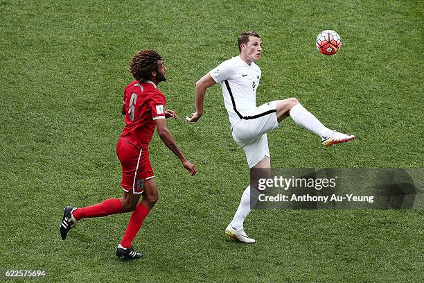 Chris Wood of New Zealand controls the ball against Cedric Sansot of New Caledonia during the 2018 FIFA World Cup Qualifier match between the New...