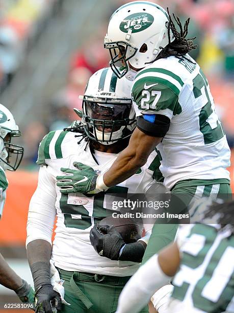 Linebacker Lorenzo Mauldin of the New York Jets celebrates an interception with cornerback Darryl Roberts during a game against the Cleveland Browns...