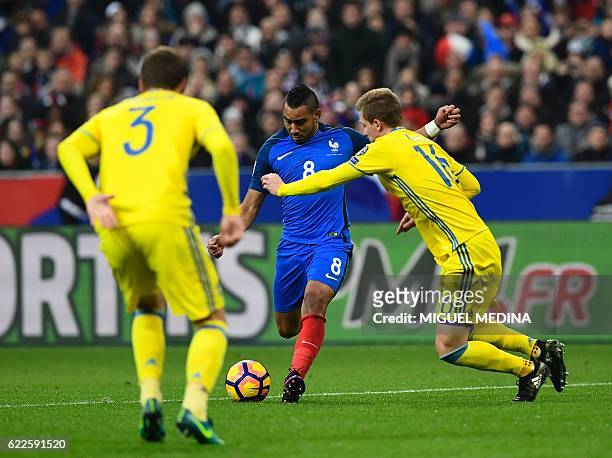France's midfielder Dimitri Payet vies with Sweden's Victor Nilsson Lindelöf and Sweden's defender Emil Krafth during the 2018 World Cup group A...
