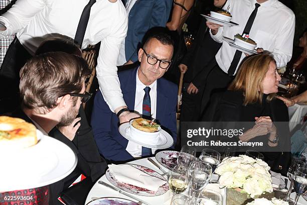 Steven Kolb being served chicken pot pie at the 13th Annual CFDA/Vogue Fashion Fund Awards at Spring Studios on November 7, 2016 in New York City.