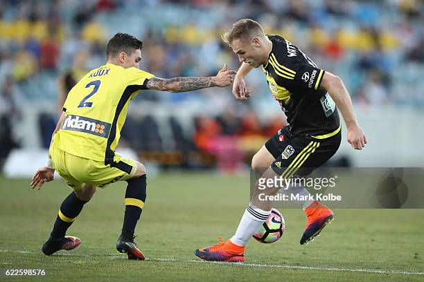Storm Roux of the Mariners defends against Hamish Watson of the Phoenix during the round six A-League match between the Central Coast Mariners and...