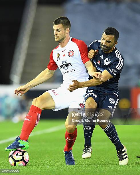 Brendan Hamill of the Wanderers is challenged by Fahid Ben Khalfallah of the Victory during the round six A-League match between the Melbourne...