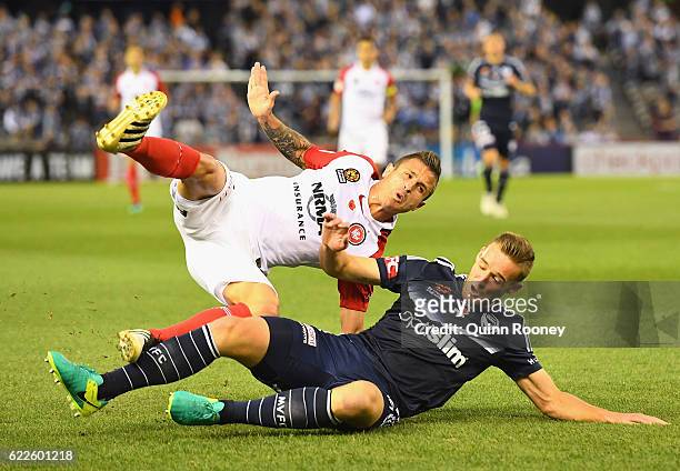 Nicholas Martinez of the Wanderers is tackled by Nicholas Ansell of the Victory during the round six A-League match between the Melbourne Victory and...