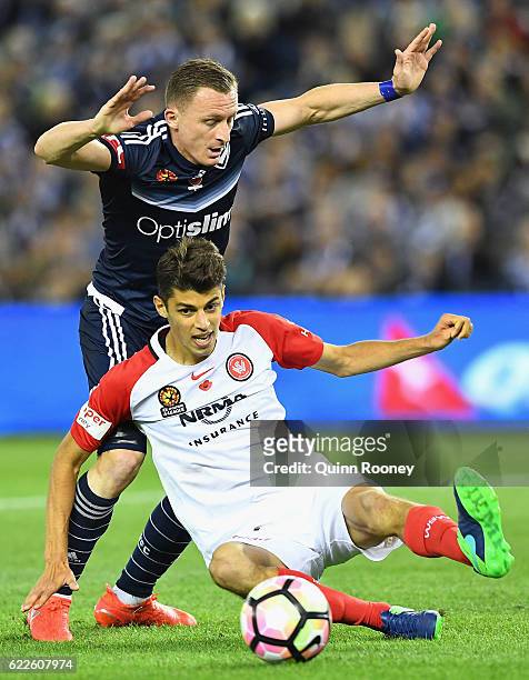 Besart Berisha of the Victory and Jonathan Aspropotamitis of the Wanderers compete for the ball during the round six A-League match between the...