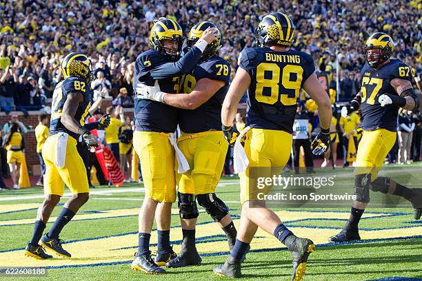 Michigan Wolverines quarterback Wilton Speight is congratulated by Michigan Wolverines offensive lineman Erik Magnuson after scoring a touchdown...