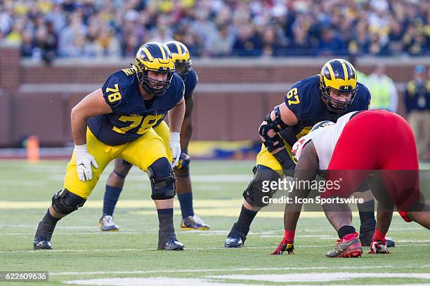 Michigan Wolverines offensive lineman Erik Magnuson and offensive lineman Kyle Kalis wait for the ball to be snapped during game action between the...