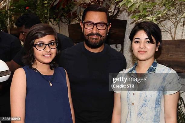 Indian Bollywood actors Aamir Khan , Suhani Bhatnagar and Zaria Wasim pose for a photograph during a promotional event for the forthcoming Hindi film...