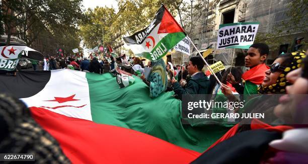 Activists for the independence of the Western Sahara wave flags and banners reading "Sahara: Only Pace!" during an annual protest organised by the...