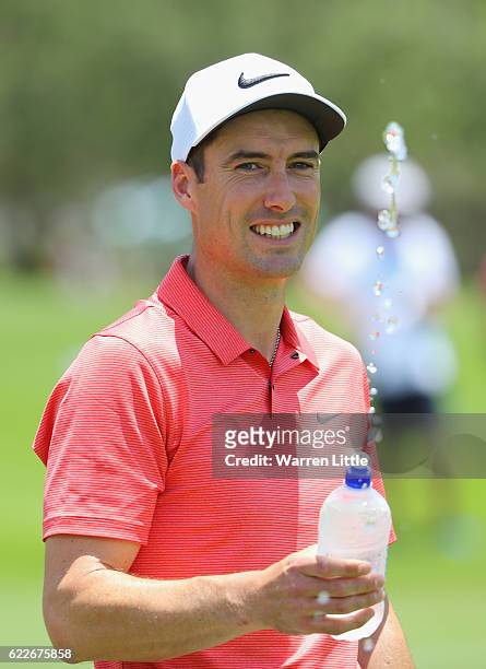 Ross Fisher of England squirts water to the camera during the third round of the Nedbank Golf Challenge at the Gary Player CC on November 12, 2016 in...